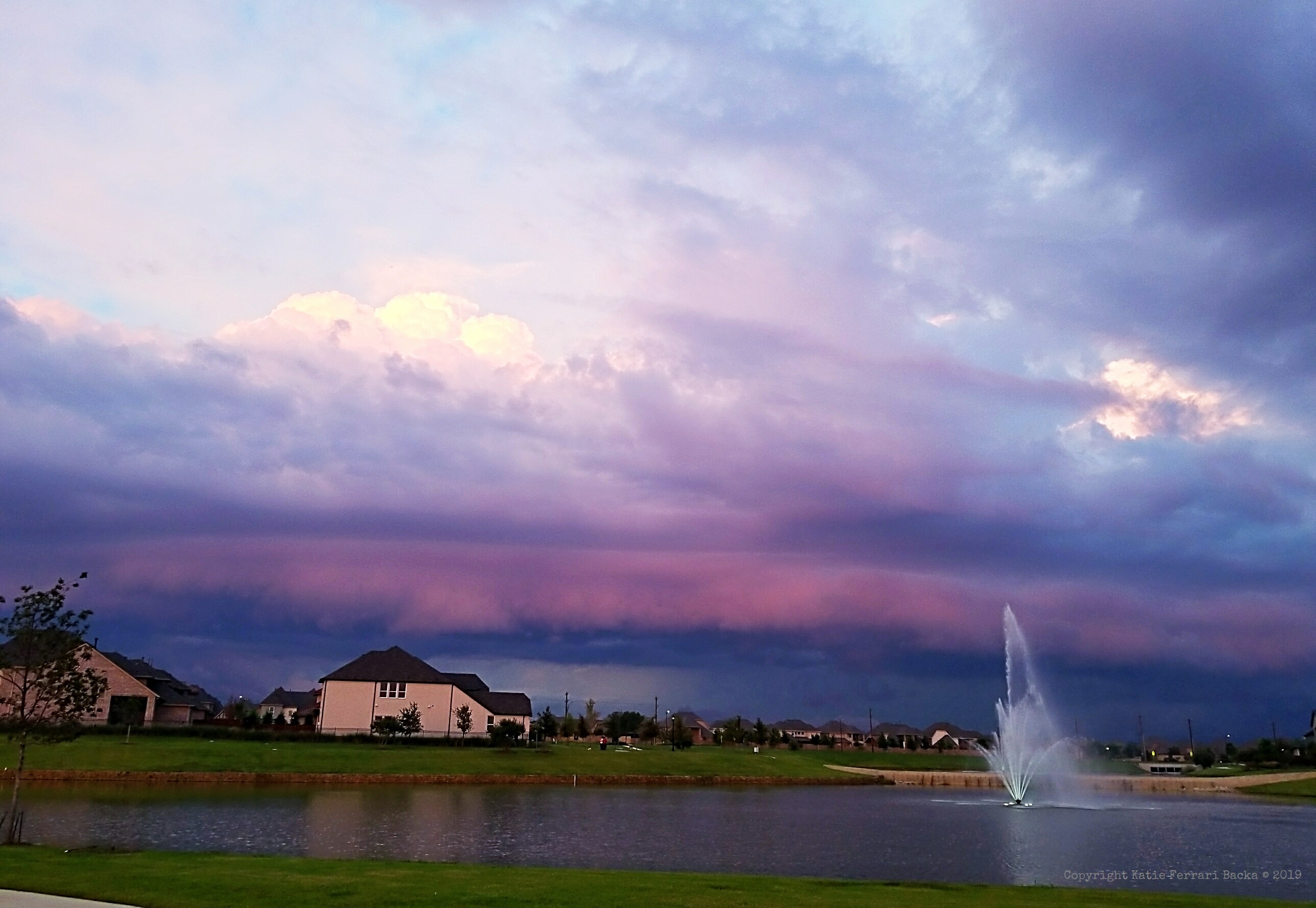 View of a storm coming in over a water fountain