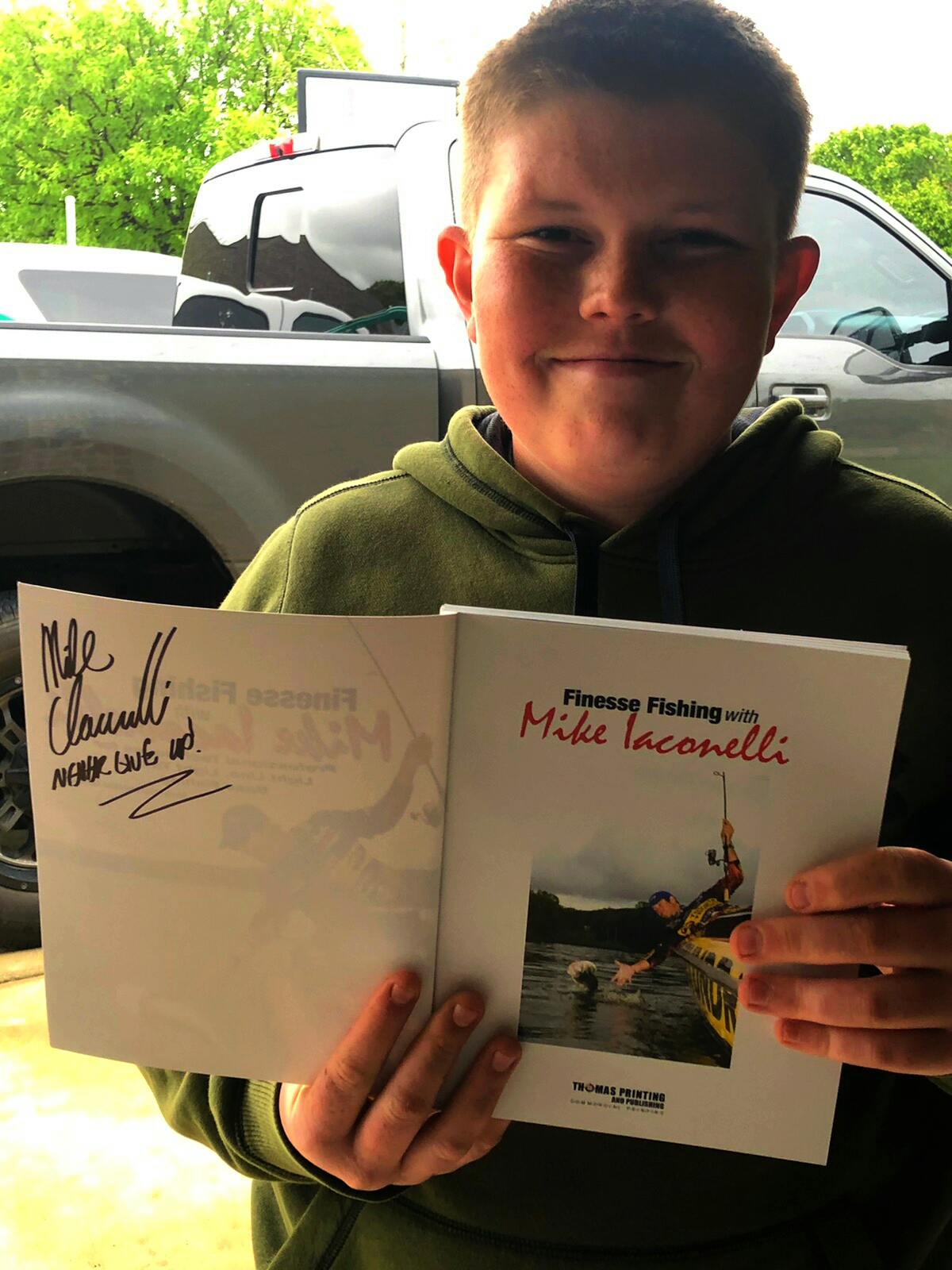 Hunter holding his signed copy of 'Finesse Fishing with Mike Iaconelli'