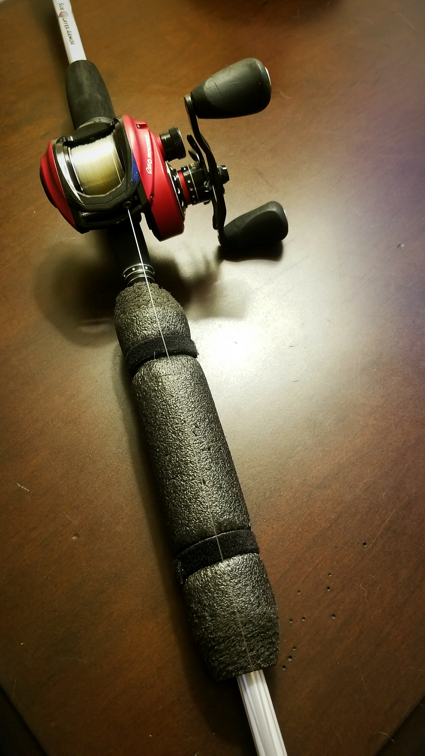 Abu Garcia rod and reel with a black rod float attached to the blank