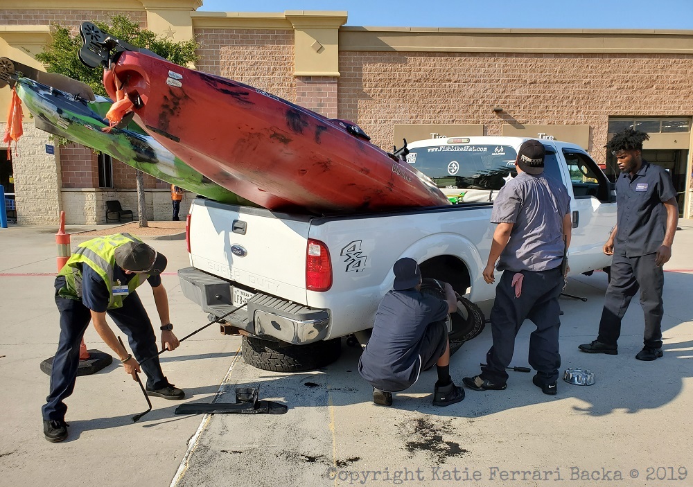 A group of Walmart employees working on Kat and Ryan's truck in the parking lot of the Walmart auto center in Little Elm Texas