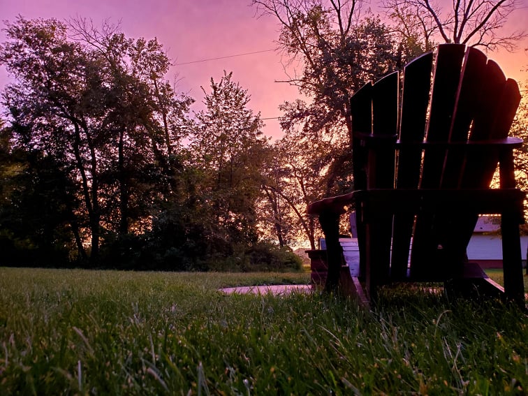 A view of a chair in the yard at sunset in Stoddard, Wisconsin