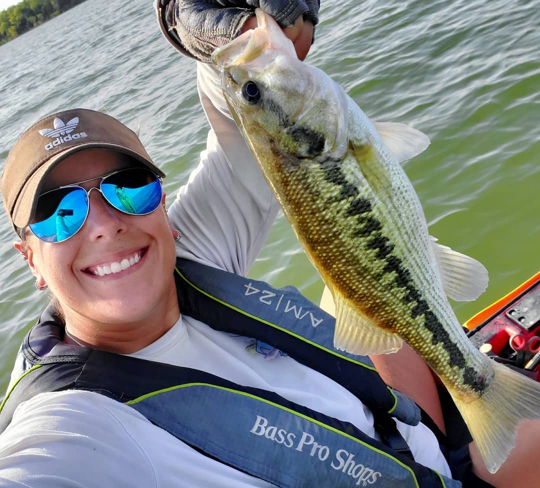 Katie holding a little spotted bass