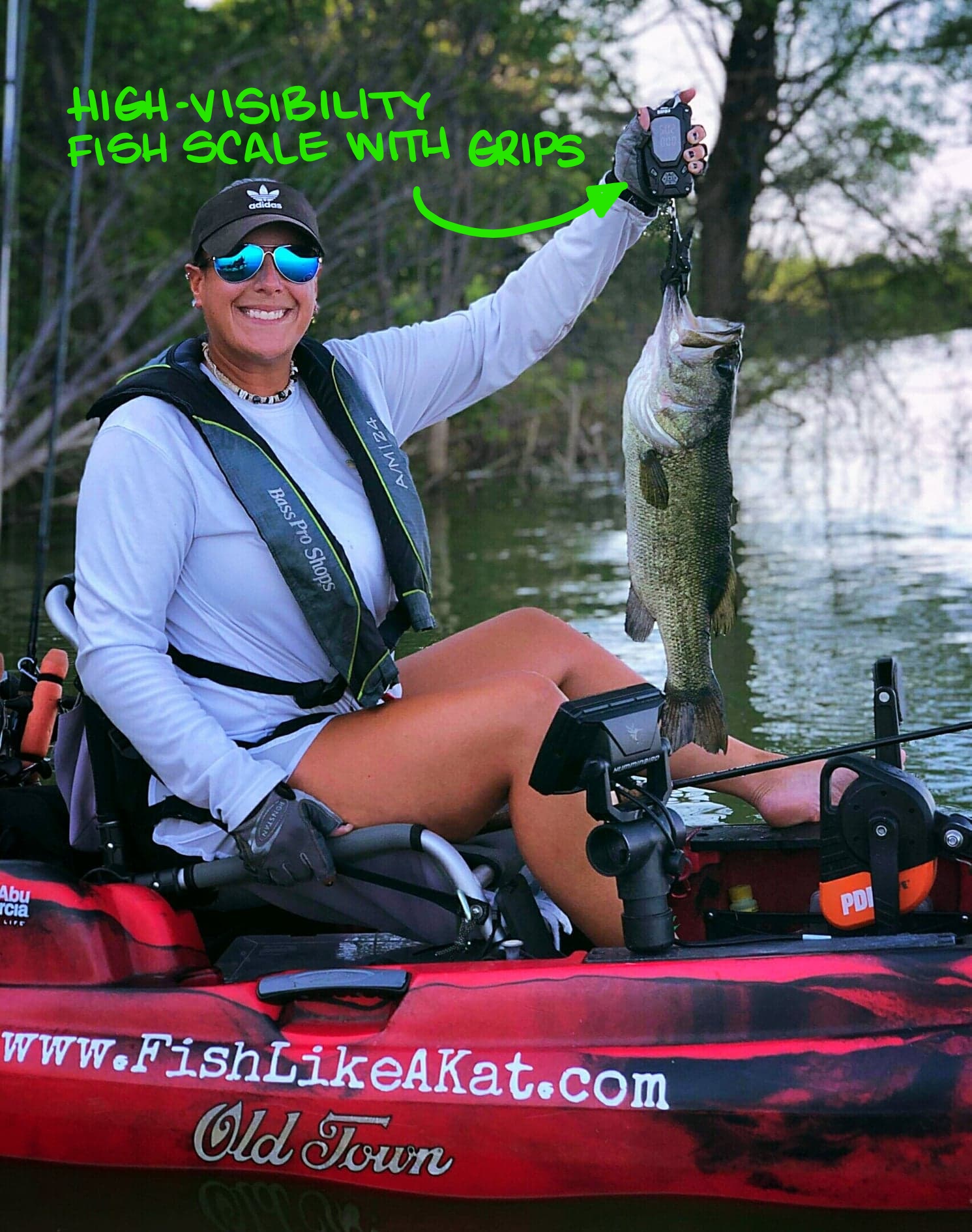 Kat in her kayak weighing a 5 pound fish