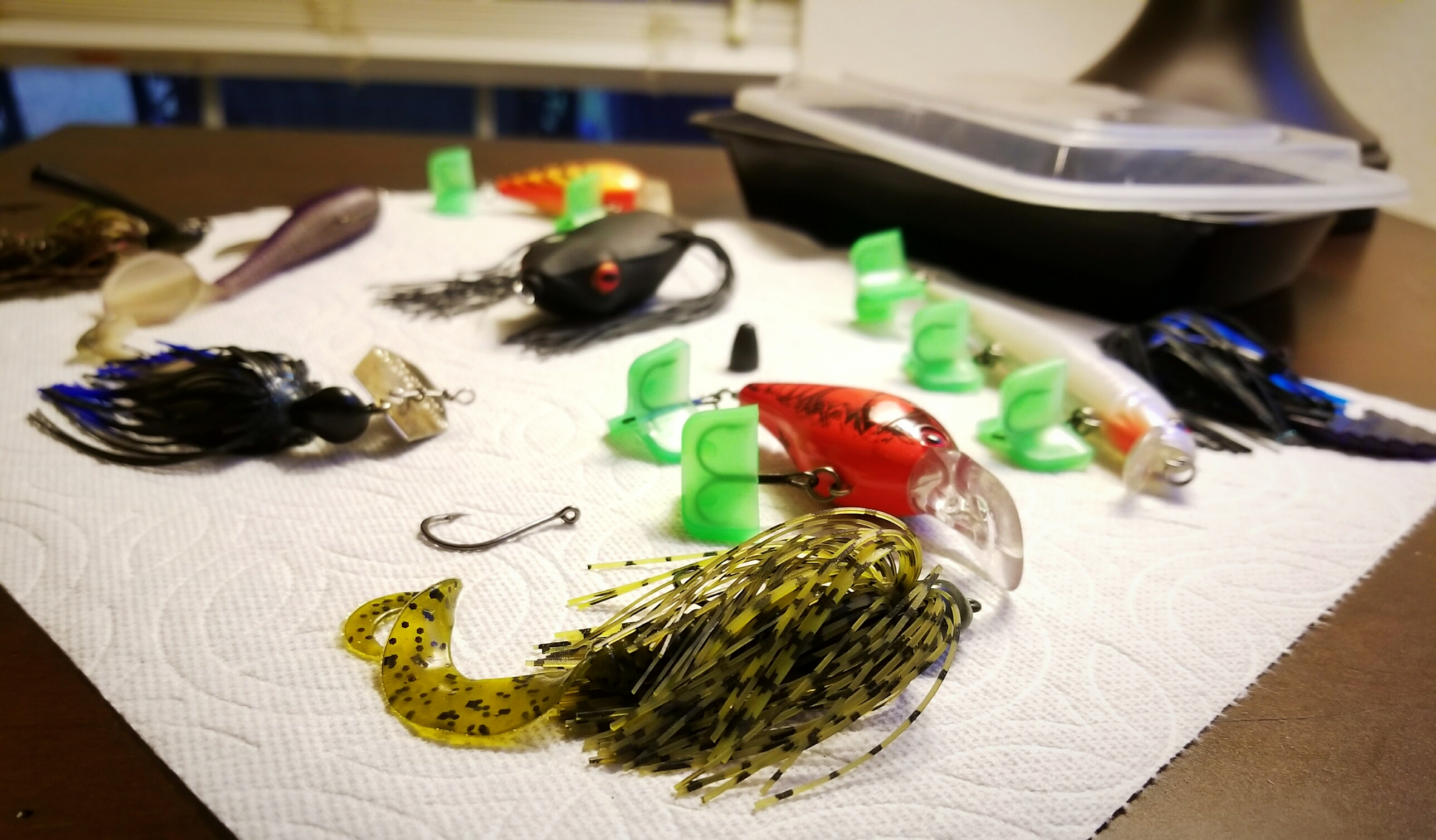 Various types of fishing lures drying on a paper towel