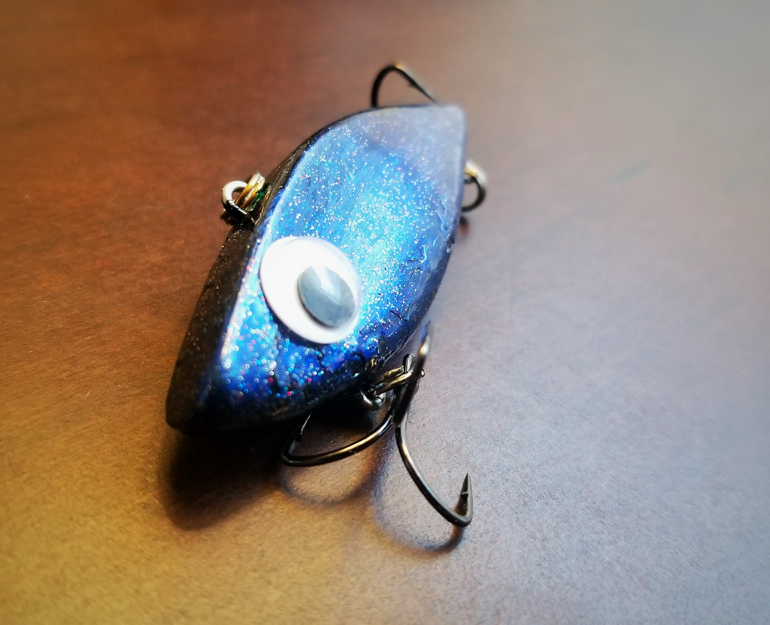 Black and blue painted Rattle Trap lure with glitter clear coat and googly eyes