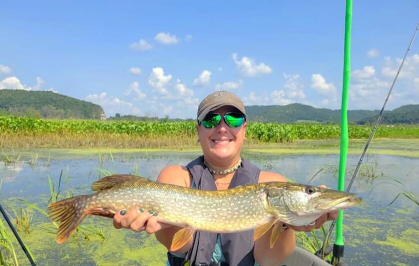 Katie holding up her first pike
